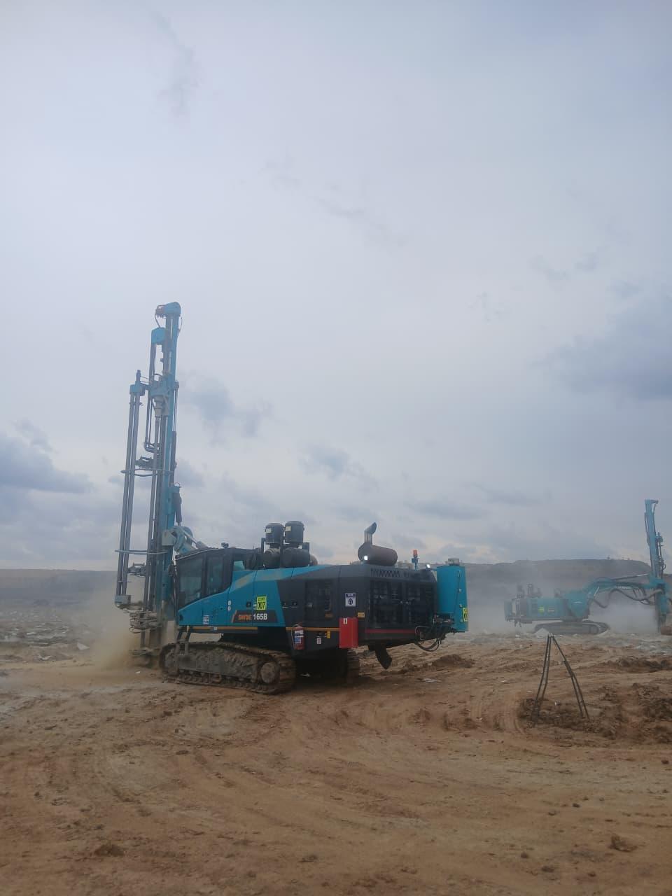 Sunward drill rig drilling a production blast pattern